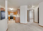 Thumbnail 3 of 9 - A kitchen area with a refrigerator, oven, and cabinets.