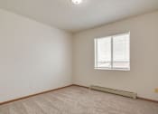 Thumbnail 7 of 9 - A room with a window and a radiator on the floor.
