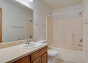 Thumbnail 8 of 9 - A bathroom with a sink, toilet, and bathtub.