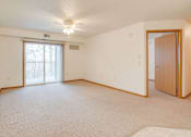 Thumbnail 8 of 11 - A room with a carpeted floor and a ceiling fan at Savanna Apartments, St Cloud, MN, 56303
