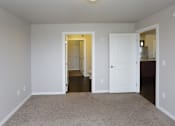 Thumbnail 7 of 10 - A room with a carpeted floor and white walls.