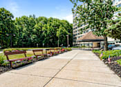 Thumbnail 4 of 25 - a row of benches on a sidewalk in front of a building