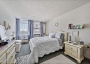 Thumbnail 19 of 25 - a bedroom with a bed and a dresser and a tv