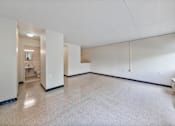 Thumbnail 25 of 25 - the living room and dining room of an empty apartment with white walls and tile floors