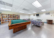 Thumbnail 18 of 25 - a game room with a pool table and a couch