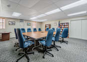 Thumbnail 12 of 25 - a conference room with a table and chairs