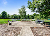 Thumbnail 4 of 25 - a park with benches and a square with a fountain