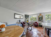 Thumbnail 21 of 25 - a dining room and living room with a table and chairs