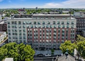 Thumbnail 1 of 25 - an aerial view of a large building with trees in front of it