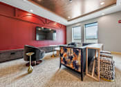 Thumbnail 16 of 25 - a lobby with a reception desk and a tv on the wall