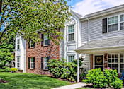 Thumbnail 2 of 19 - Beautiful exterior of Westridge gardens with green grass, tall trees, and bushes