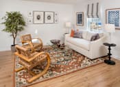Thumbnail 13 of 19 - Furnished living room with a sofa, coffee table, and high ceiling at Westridge Gardens