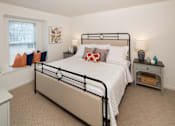 Thumbnail 4 of 19 - Bedroom with a queen size bed adorned by two nightstands and window with a small nook