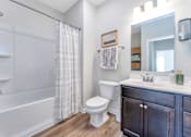 Thumbnail 19 of 44 - a bathroom with a shower toilet and sink and a mirror
