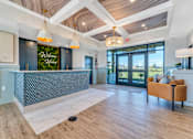 Thumbnail 31 of 44 - a lobby with a reception desk and sliding glass doors