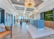 Thumbnail 33 of 44 - the lobby of a hotel with a reception desk and a green wall
