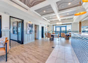 Thumbnail 2 of 44 - the lobby of a resort with tables and chairs and a balcony