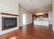 Thumbnail 8 of 49 - A large open living room with a fireplace and wooden floors.