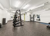 Thumbnail 72 of 230 - A gym with a variety of equipment including a rowing machine.