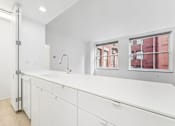 Thumbnail 36 of 230 - A white bathroom with a sink and a window.