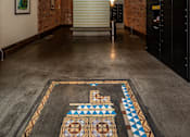 Thumbnail 4 of 12 - a large room with brick walls and a large rug on the floor