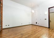 Thumbnail 8 of 12 - a living room with a hard wood floor and white walls