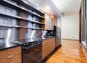 Thumbnail 7 of 12 - a kitchen with stainless steel appliances and wooden cabinets