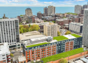 Thumbnail 2 of 45 - an aerial view of a city with a green roof on a building