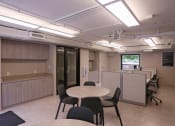 Thumbnail 21 of 39 - Resident Business Center with tables, seating, and window at Eden Commons, Illinois