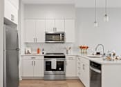 Thumbnail 14 of 50 - Chef-Inspired Kitchens Feature Stainless Steel Appliances at 23rd Place Apartments, Chicago