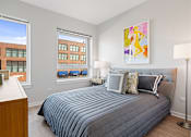 Thumbnail 8 of 50 - Bedroom With Expansive Windows at 23rd Place Apartments, Chicago, 60616