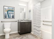 Thumbnail 13 of 45 - a bathroom with a toilet and a shower and a sink