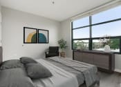 Thumbnail 18 of 45 - a bedroom with a bed and a large window