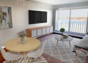 Thumbnail 5 of 17 - Cedarvale Highlands Studio Elite Living room view with space for small dining table, couch, coffee table, and personal patio
