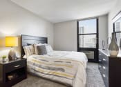Thumbnail 11 of 39 - a bedroom with a large bed and a large window at Eden Commons, Illinois, 60616