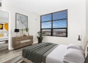Thumbnail 14 of 45 - a bedroom with a bed and a large window