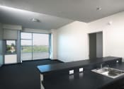 Thumbnail 24 of 59 - Park Boulevard Living Room Shot with partial view of kitchen counter, and view of large floor to ceiling windows