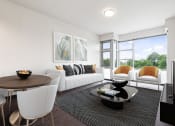 Thumbnail 11 of 59 - A modern living room with a white sofa, a wooden table, and a large window.