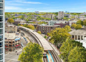 Thumbnail 3 of 45 - an aerial view of a city with train tracks