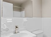 Thumbnail 15 of 19 - Modern bathroom with white subway tile at Dominion Towers Apartments, Arlington