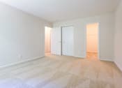 Thumbnail 15 of 23 - A room with a carpeted floor and two white doors at Potomac Ridge Apartments, Woodbridge, 22191