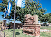 Thumbnail 1 of 33 - Stone entrance monument sign with landscaping at Cantera Apartments, Texas, 79935