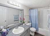 Thumbnail 41 of 41 - A bathroom with a sink, toilet, and shower.