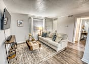 Thumbnail 28 of 37 - Furnished living room with sectional sofa and area rug at Le Montreaux Apartments, Austin, Texas