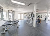 Thumbnail 12 of 33 - Fitness center with weight machines and equipment at Cantera Apartments, Texas, 79935