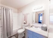 Thumbnail 29 of 33 - Bathroom with vanity and tub shower combo at Cantera Apartments, El Paso, Texas