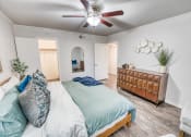 Thumbnail 34 of 36 - a bedroom with a bed and a ceiling fan