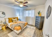 Thumbnail 31 of 36 - a bedroom with a bed and a ceiling fan