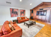 Thumbnail 16 of 36 - a living room with two couches and a table at Juniper Springs Apartments, Austin, TX