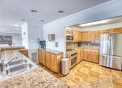 Thumbnail 11 of 36 - a large kitchen with a round ceiling and wood cabinets at Juniper Springs Apartments, Austin, TX
